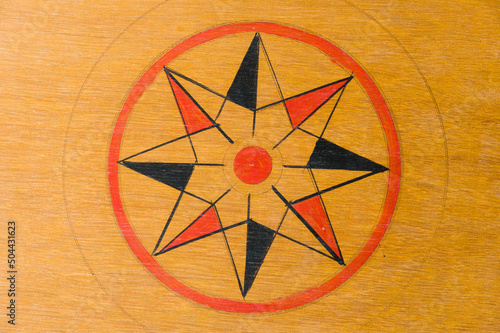 Center star on a wooden carrom board