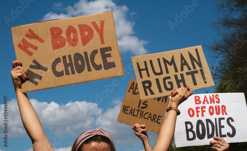 Protesters holding signs My Body My Choice, Human right, Bans Off Our Bodies, Abortion Is Healthcare. People with placards supporting abortion rights at protest rally demonstration. © Longfin Media