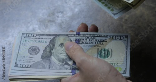 Girl counting dollars, hundred dollar bills close-up.