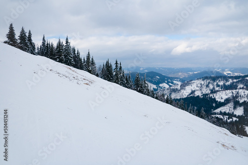 View from the top of mountain on forest in frost and low cloud. photo