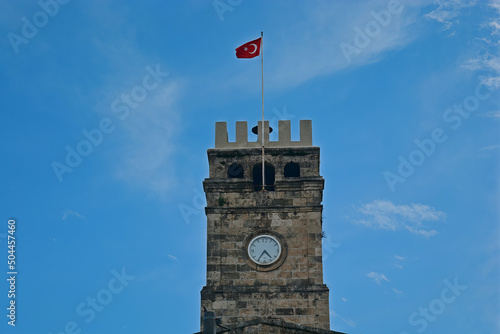 castle shaped clock tower in turkey, turkish flag