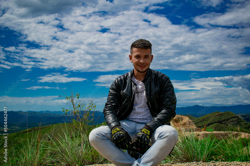 man smiling with a landscape in the background man smiling with a landscape in the background