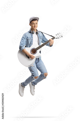 Happy guy jumping and playing an acoustic guitar © Ljupco Smokovski