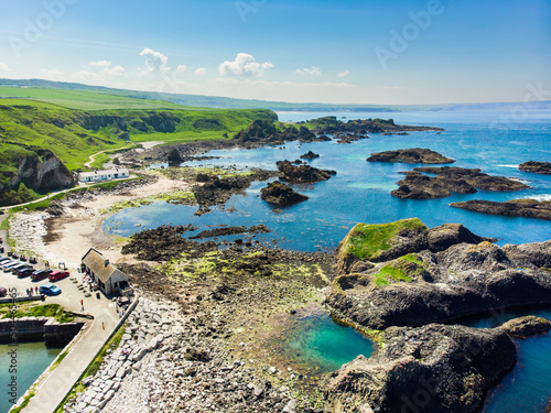 Vivid emerald-green water at Ballintoy harbour along the Causeway Coast in County Antrim.