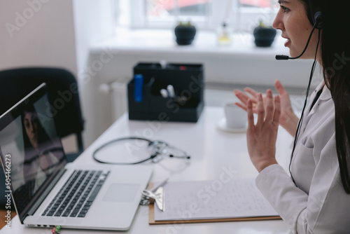 Physician consulting clients online 