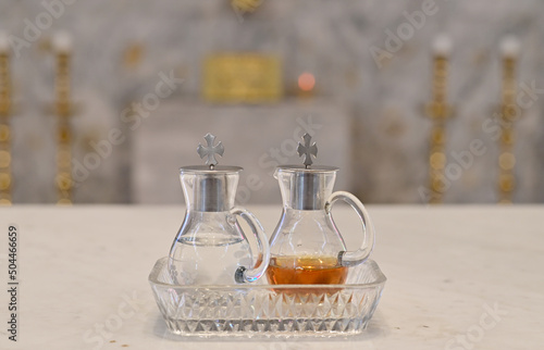 Closeup of Holy Wine and water in a small clear glass bottle to become the blood of Jesus Christ for performing Catholic religious ceremonies (Mass) at Thailand. photo