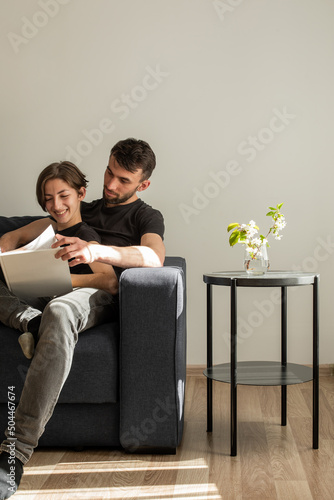 Happy couple reads book photo