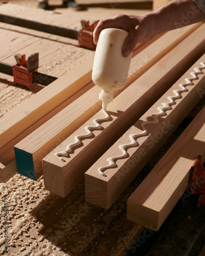 Woodworker Craftsman gluing together a table.  photo