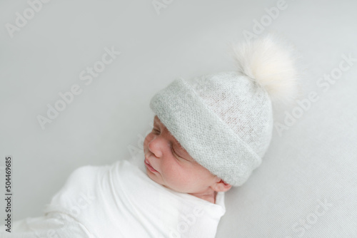 Sleeping baby in knit hat photo