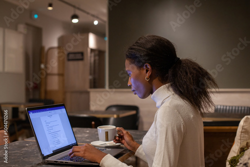 serious confident professional woman working on computer photo