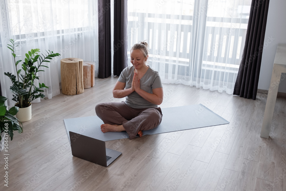 Woman greeting online instructor with namaste gesture Woman greeting online instructor with namaste gesture