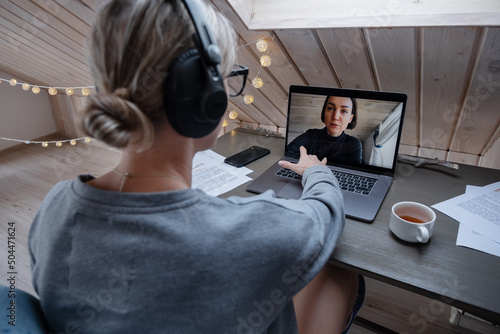 Woman using laptop during video call photo