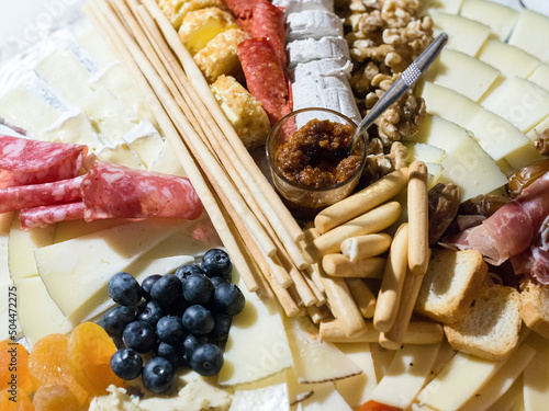 Cheese plate with fruits and cold meats