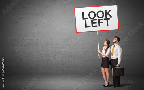 business person holding a traffic sign