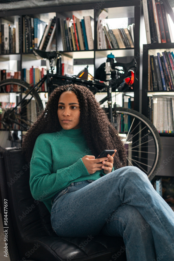 Black woman using smartphone at home Black woman using smartphone at home