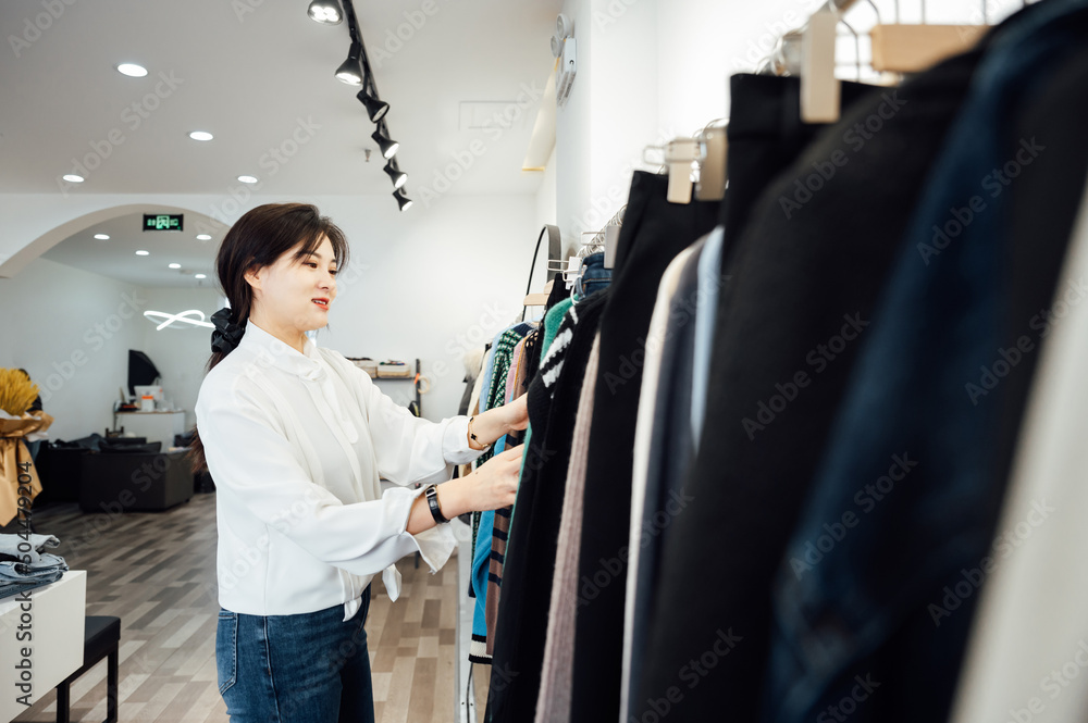 Young woman working in her clothing store Young woman working in her clothing store