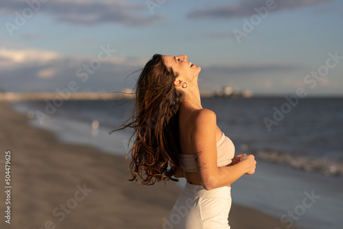 Fit Woman Smiles On The Beach