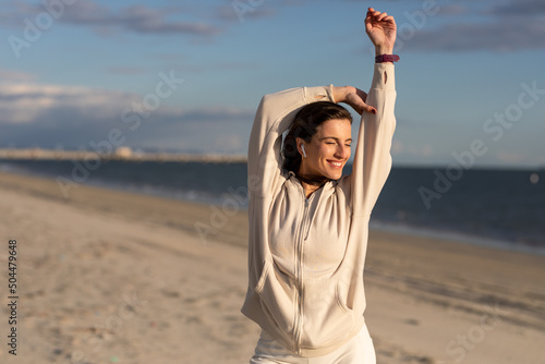 Woman Smiles While Stretching photo