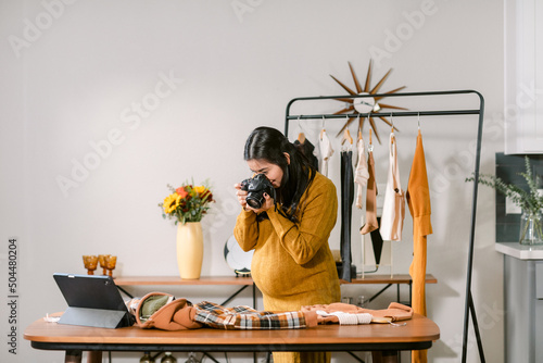 Pregnant taking photo of fashion design clothes