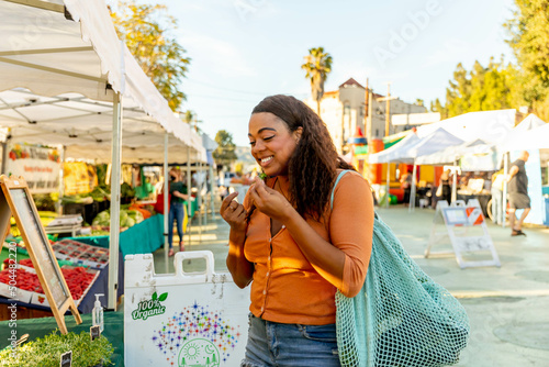 Woman Browses Organic Produce at Farmer's Market