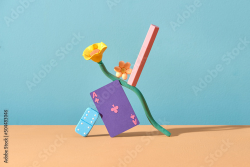 Pink unbranded lipstick balancing on flower and game board photo