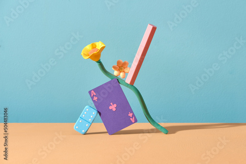 Pink unbranded lipstick balancing on flower and game board
