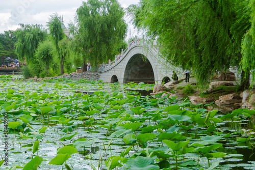 Changchun, Jilin - April 3 2021: Chinese stone arch bridge architecture on the lake in a park.