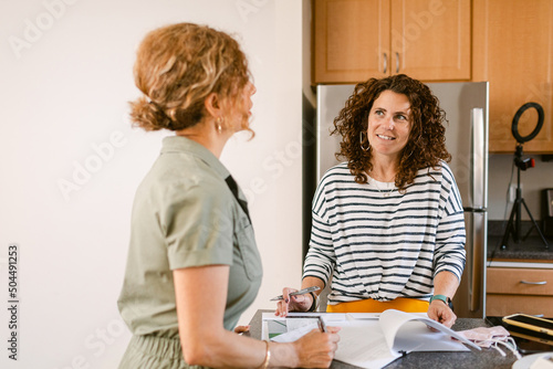 Real estate agent meeting with client in kitchen