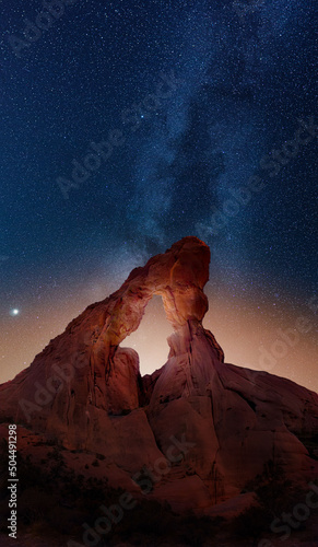 Desert arch with Milky Way extending into the sky beyond. 