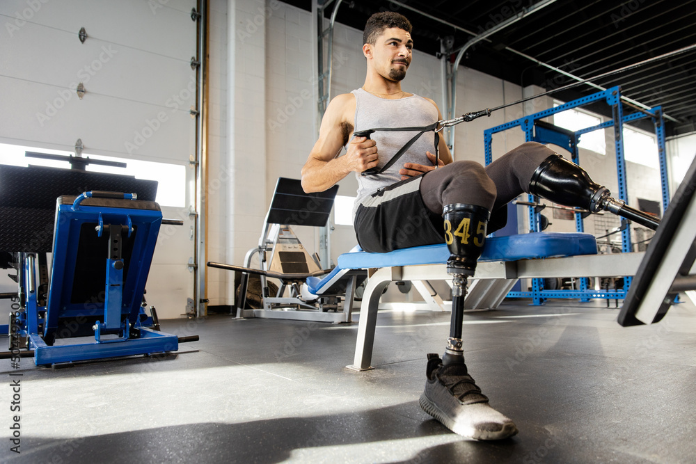 © Dylan Leeder/Stocksy - Double Leg Amputee Works Out His Arms With A Machine © Dylan Leeder/Stocksy - Double Leg Amputee Works Out His Arms With A Machine