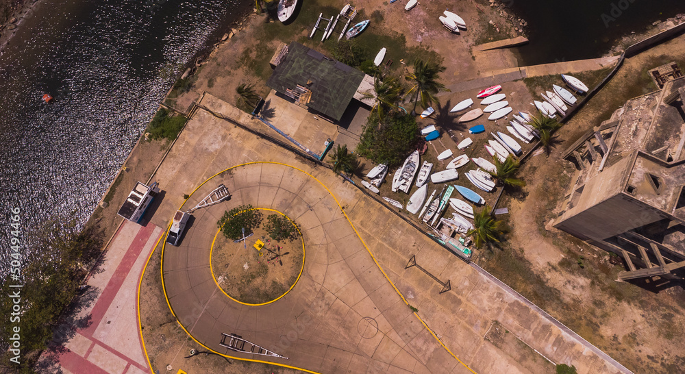 Photos from an aerial view of a drone, of a beach on a cloudy day from different angles and places, the tone of the photos is warm, in the photos you can see vegetation, trees, bushes, grass, sand, sk