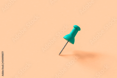 blue push pins on pink background