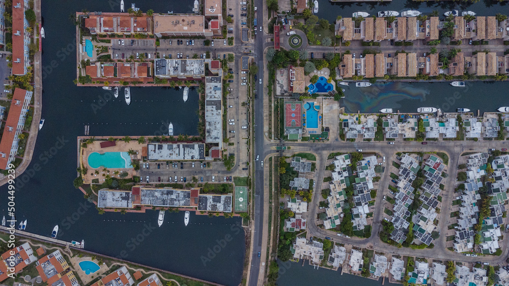 aerial drone shots of the beach city of Lechería, with a residential area of Venice-style stilt houses, you can see houses, editions, canals, houses on the sea, stilt houses, parking lots, swimming po aerial drone shots of the beach city of Lechería, with a residential area of Venice-style stilt houses, you can see houses, editions, canals, houses on the sea, stilt houses, parking lots, swimming po