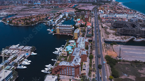 aerial drone shots of the beach city of Lechería, with a residential area of Venice-style stilt houses, you can see houses, editions, canals, houses on the sea, stilt houses, parking lots, swimming po