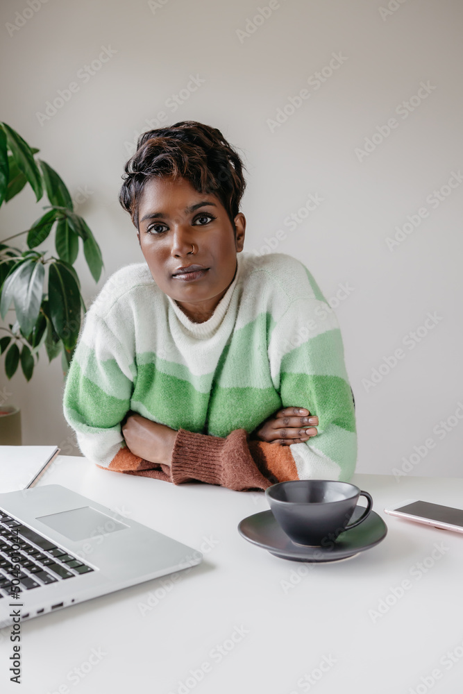 Portrait of a confident woman business owner at a desk vertical Portrait of a confident woman business owner at a desk vertical