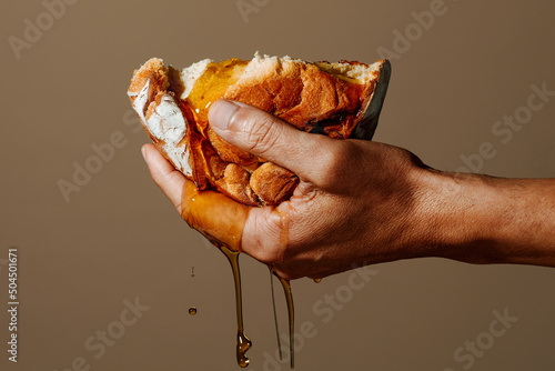 has a piece of bread soaked in olive oil photo