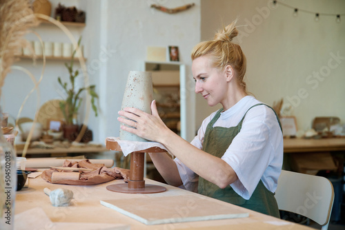 Young ceramist makes handmade vases photo
