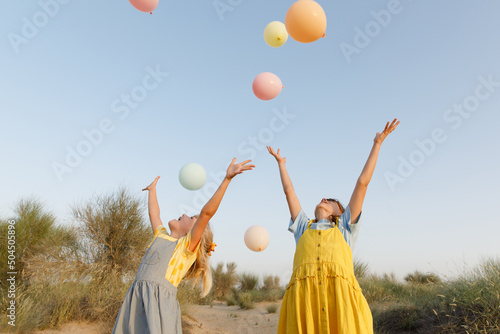 Children with balloons outdoors