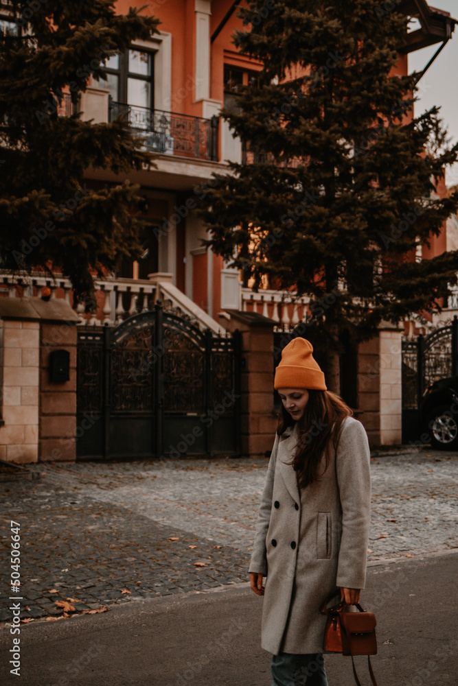 Fashion street style in cold fall weather of a young girl on the street