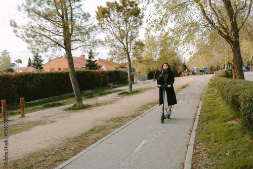 Wallpaper Mural Woman  riding an e-scooter in bike lane. Sustainable city concept. Torontodigital.ca