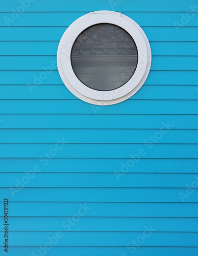round window in blue wall photo