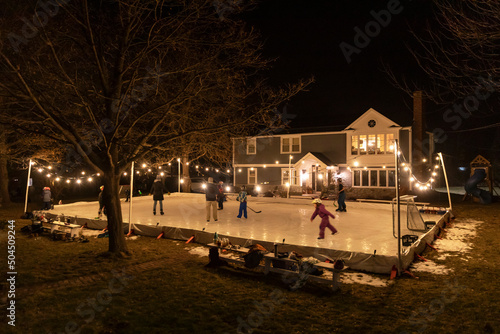 Family Winter Lifestyle Home Backyard hockey  Skating Rink  photo