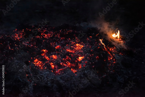 Smoldering coals and fire. Fire. bonfire. Dark photo.