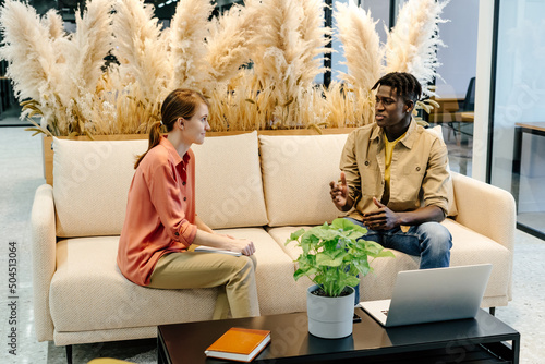 Colleagues resolving work issues in coworking space