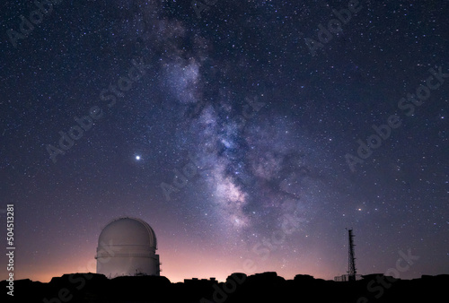 Milky way over an astronomical observatory telescope