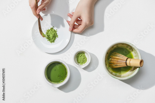 Woman making Japanese matcha green tea beverage