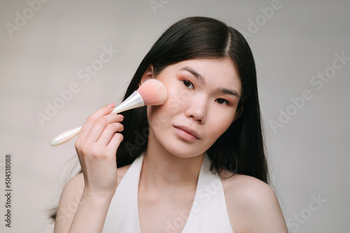 Woman applying make up