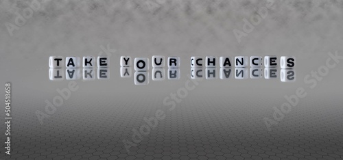 take your chances word or concept represented by black and white letter cubes on a grey horizon background stretching to infinity