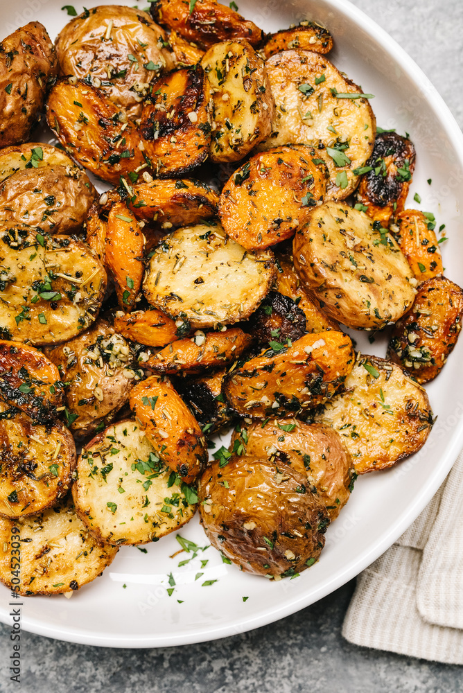 Bowl of roasted carrots and potatoes Bowl of roasted carrots and potatoes