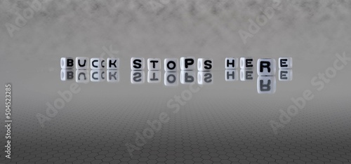 Photos buck stops here word or concept represented by black and white letter cubes on a